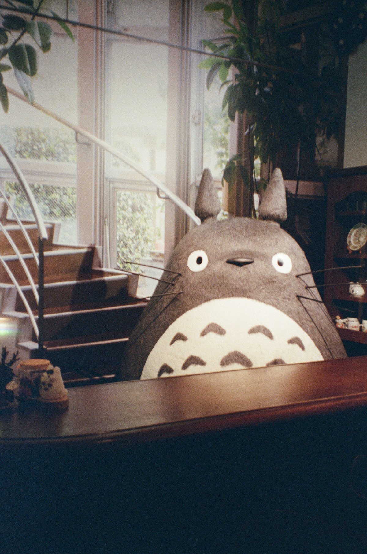 Totoro character at a wooden counter inside Ghibli Park, Nagakute, Aichi, Japan