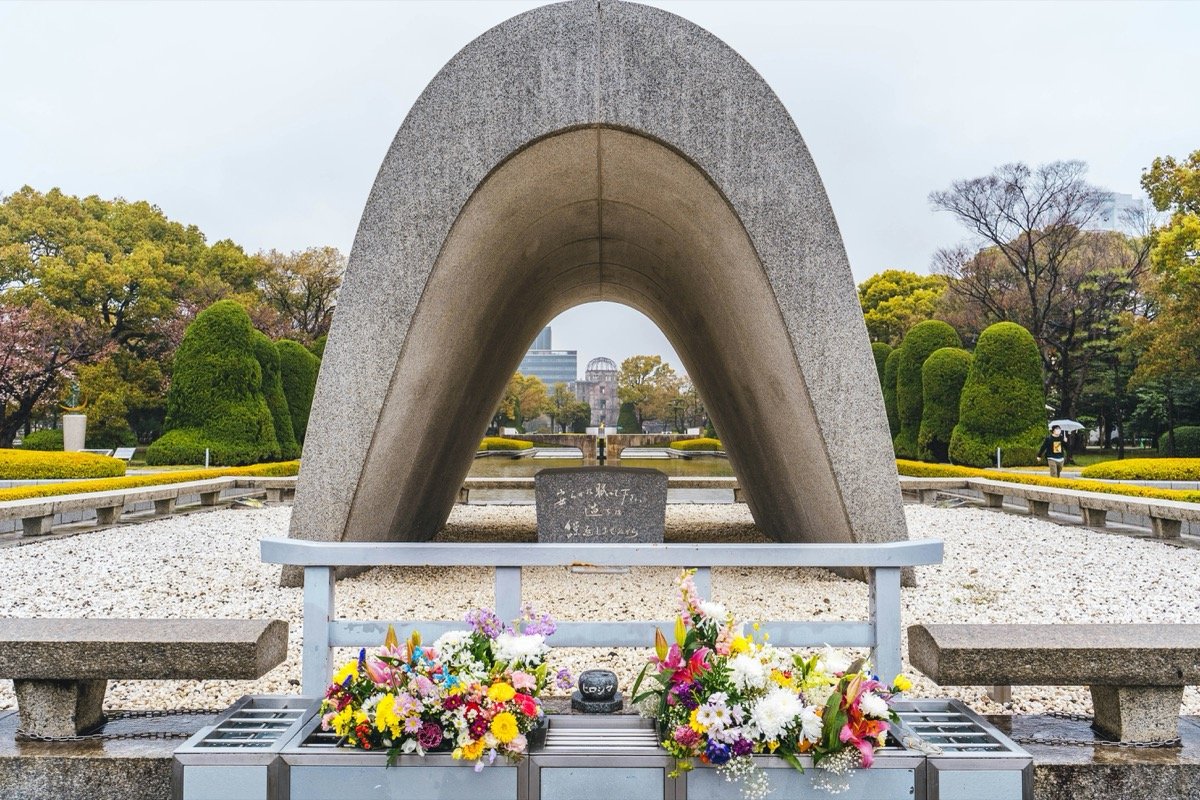 Hiroshima Peace Memorial cenotaph with the A-Bomb Dome visible through the arch, Hiroshima Peace Memorial Park