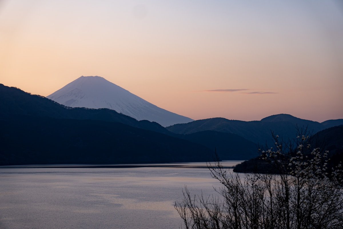 Mount Fuji rising above Lake Ashi at dusk, viewed from Hakone, Kanagawa Japan