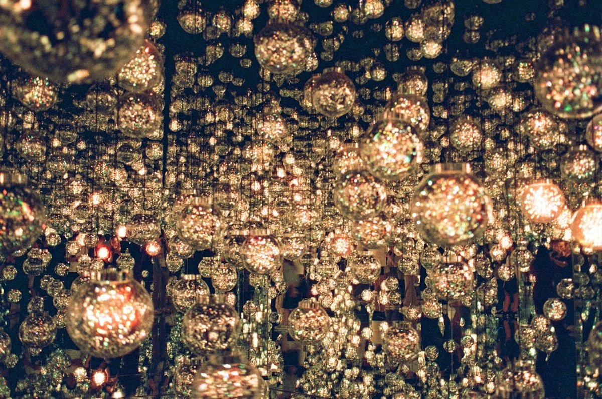 Glowing suspended orb lights in a darkened installation at teamLab digital art museum, Tokyo