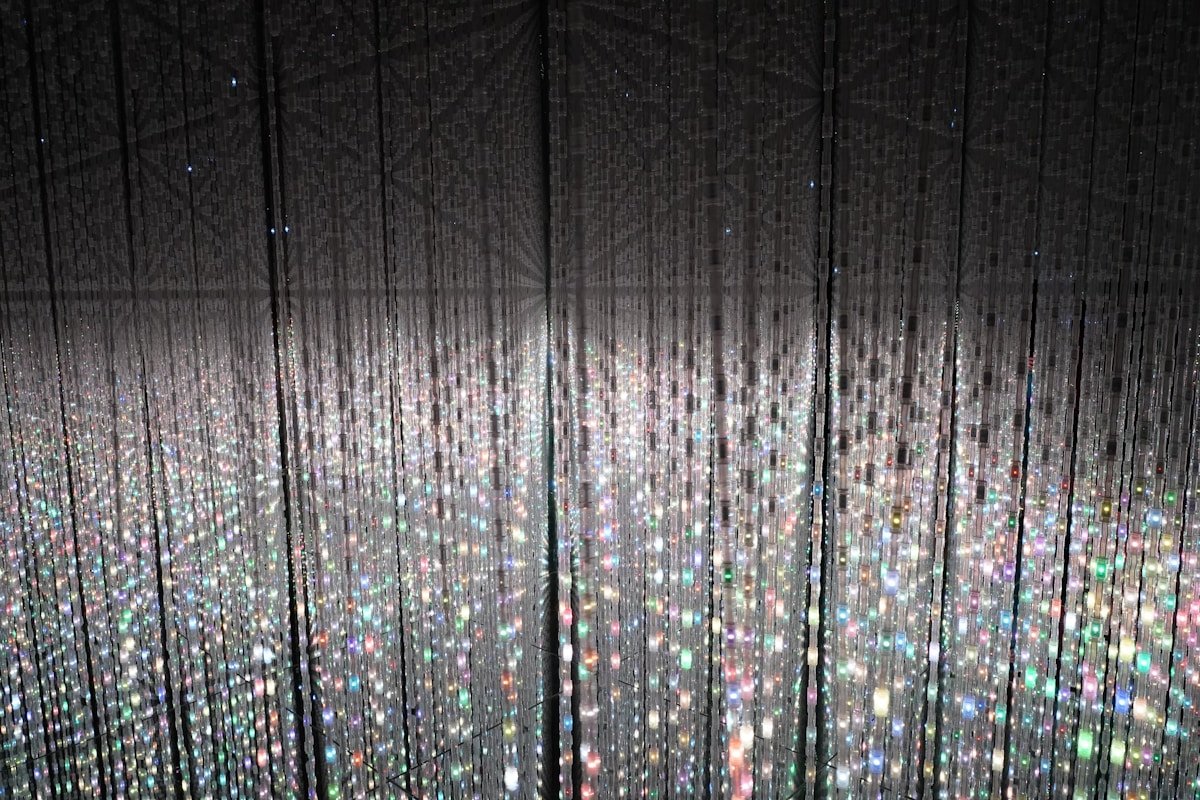 Infinite crystal light strands creating a starfield effect inside teamLab Planets in Toyosu, Tokyo