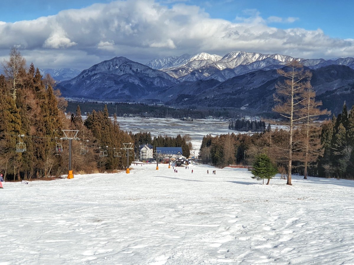 Ski slope with Hakuba Alps valley and lodge in background — where to stay in Hakuba, Nagano Japan