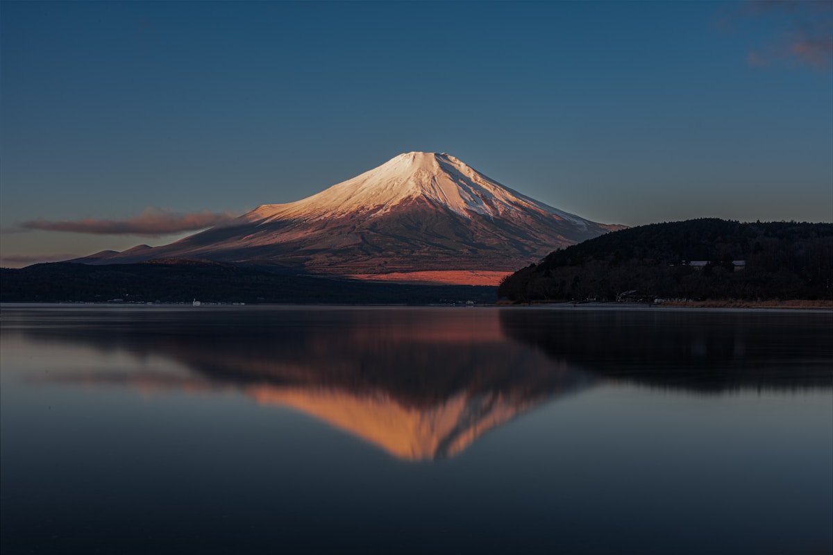 Mount Fuji reflected in the calm surface of Lake Kawaguchi at sunrise