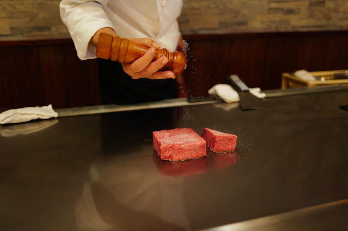 Chef preparing food at a teppanyaki counter restaurant in Kobe, Japan