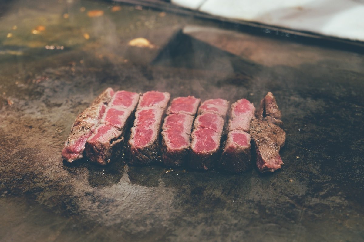 Sliced Kobe wagyu beef resting on a teppanyaki grill in Kobe, Japan