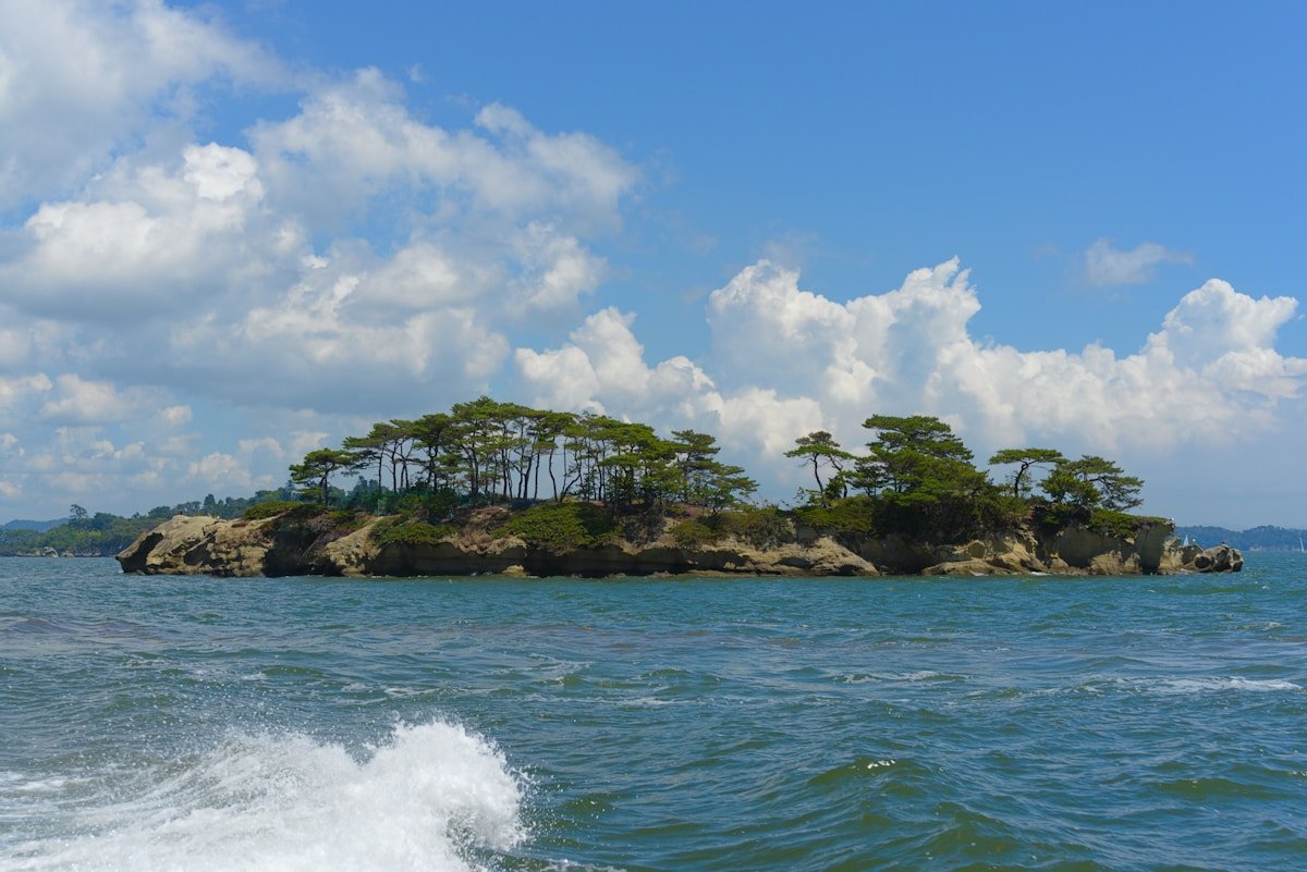 Pine-covered rocky island rising from the calm waters of Matsushima Bay, Miyagi, Japan