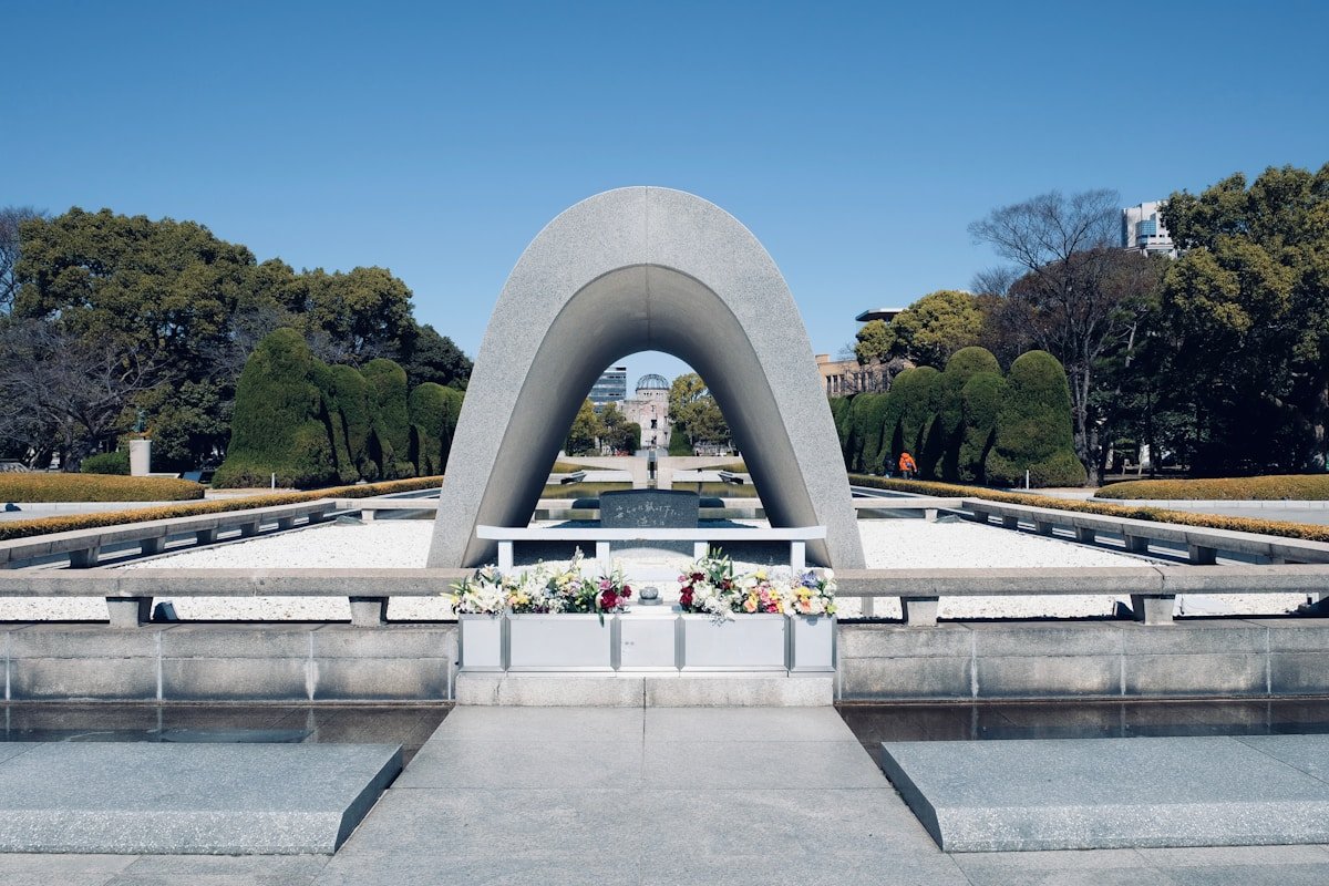 Hiroshima Peace Memorial Park cenotaph arch with the A-Bomb Dome in the background