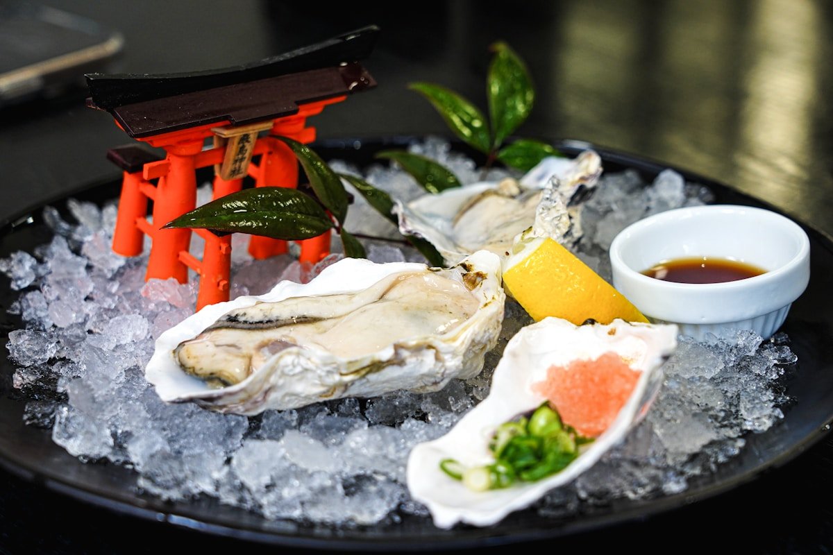 Fresh oysters on ice with a miniature torii gate decoration, Miyajima Japan