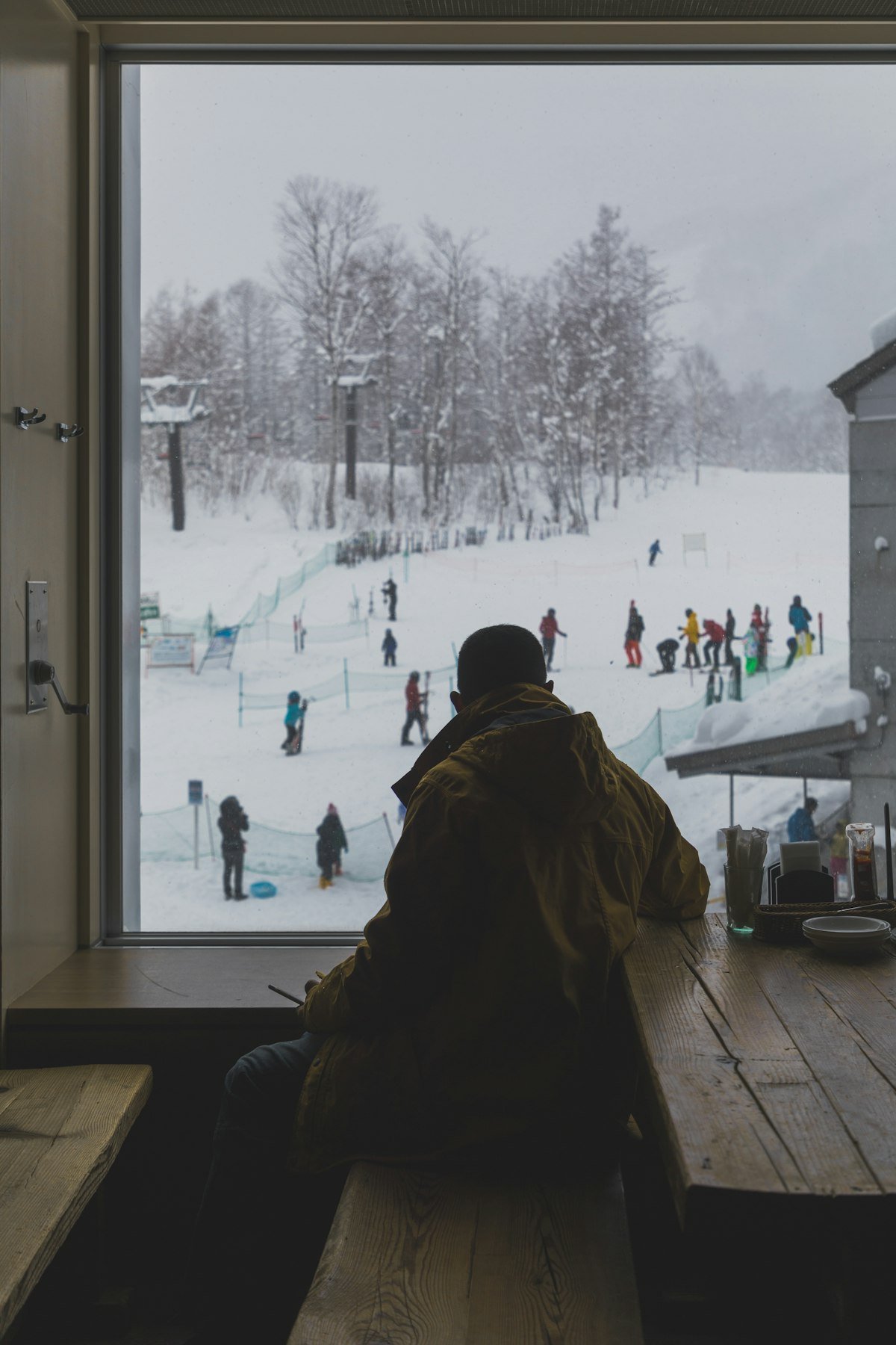 View from ski lodge window overlooking Niseko slopes — where to stay in Niseko, Hokkaido Japan