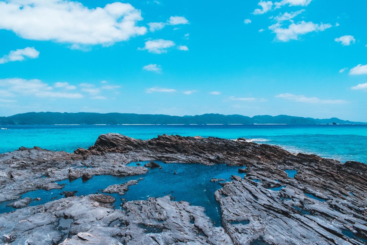 Rocky volcanic coastline with vivid turquoise water in Okinawa, Japan