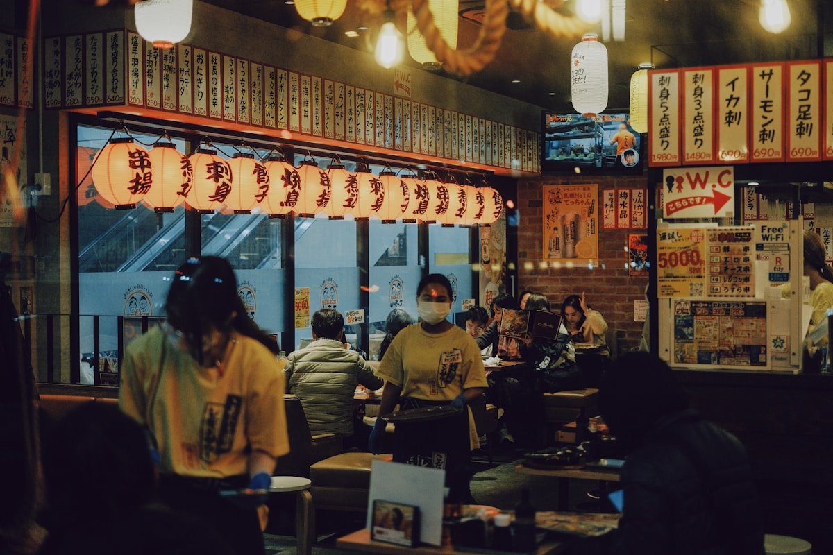 People dining together in a Japanese restaurant with glowing paper lanterns