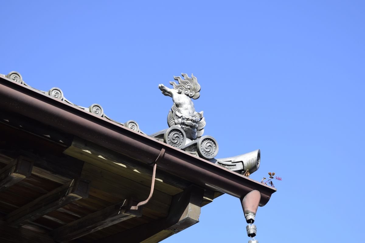 Carved shachi roof ornament against a clear blue sky in Sendai, Japan