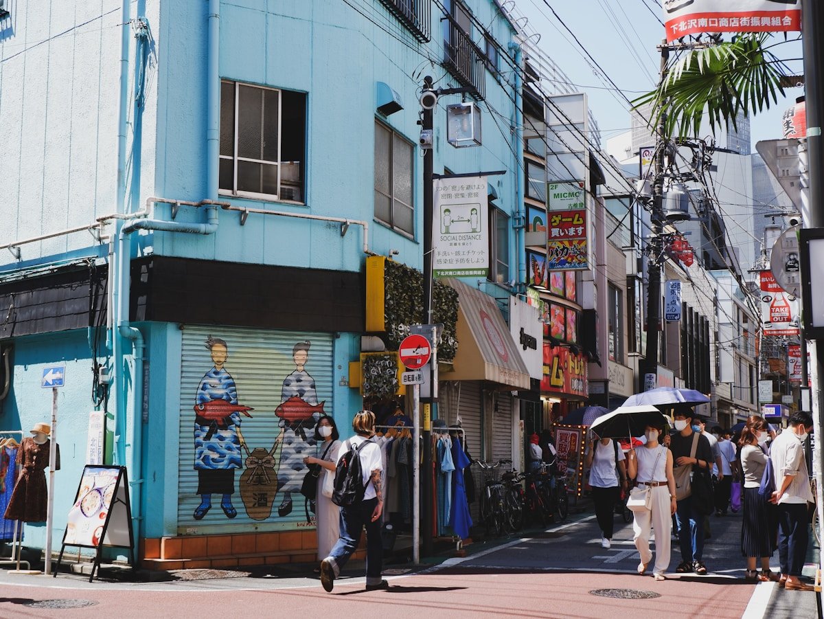Busy shopping street in Shimokitazawa Tokyo with vintage stores and pedestrians on a sunny day