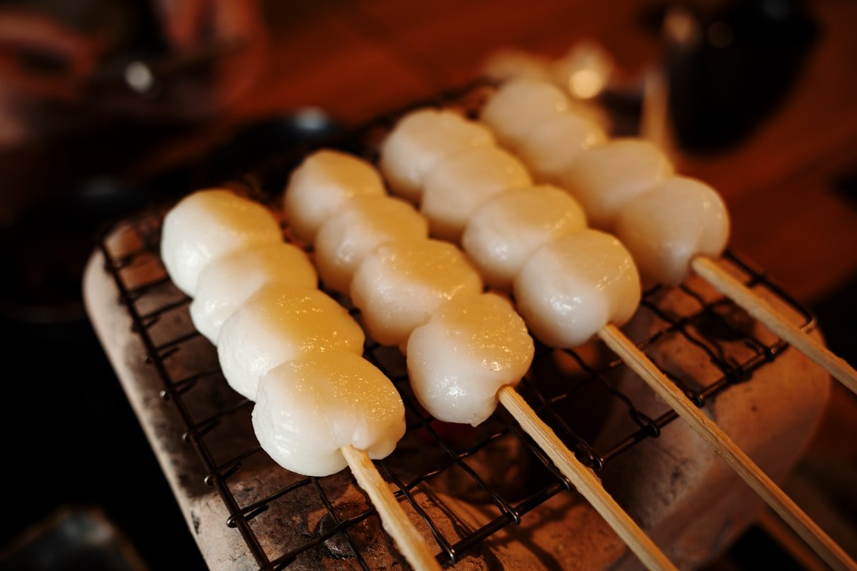 Grilled mochi dango skewers on a small barbecue grill — traditional Nara food, Japan