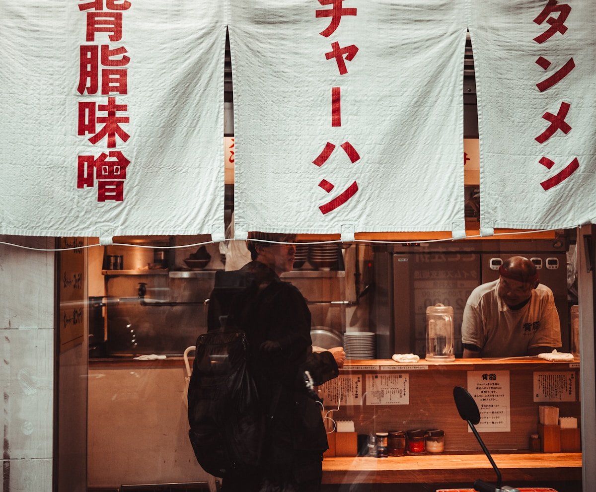 People ordering food at a Japanese restaurant counter in Shibuya, Tokyo — vegan restaurants Japan