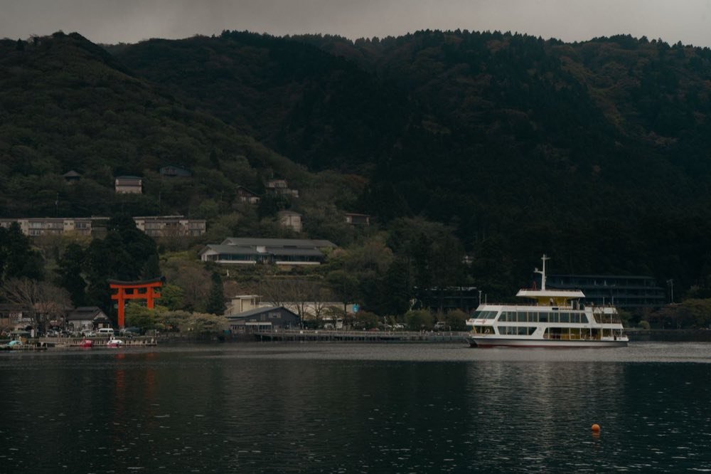 Sightseeing ferry on Lake Ashi near the red torii of Hakone Shrine