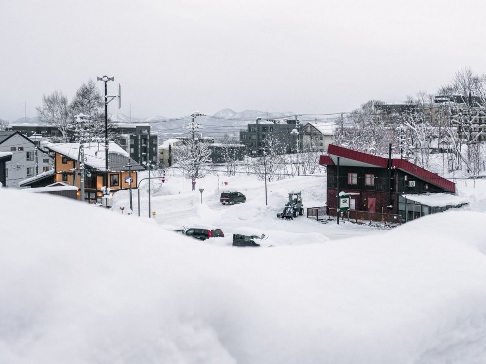 Snow-covered village roofs and mountains on a winter day in Hokkaido