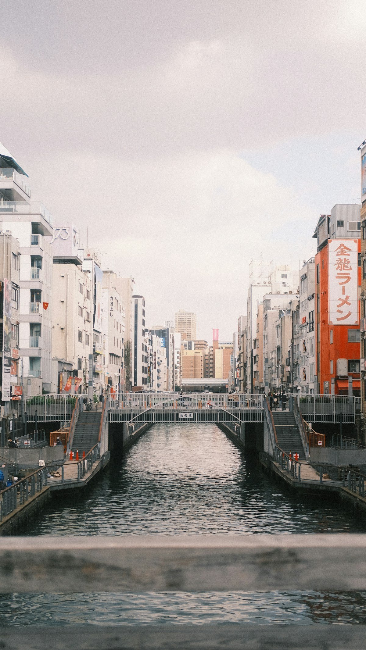 Dotonbori canal running through Osaka city with Japanese signs and buildings