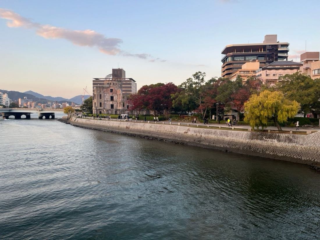Atomic Bomb Dome beside the Motoyasu River in Hiroshima at dusk with autumn colour