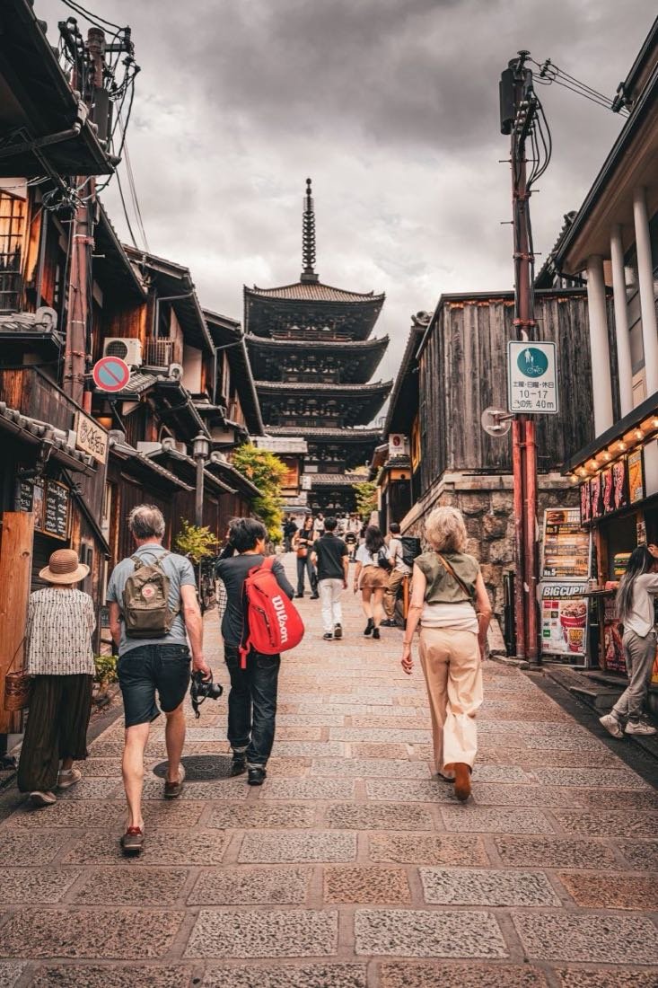 Visitors walking toward Yasaka Pagoda along a Higashiyama street in Kyoto