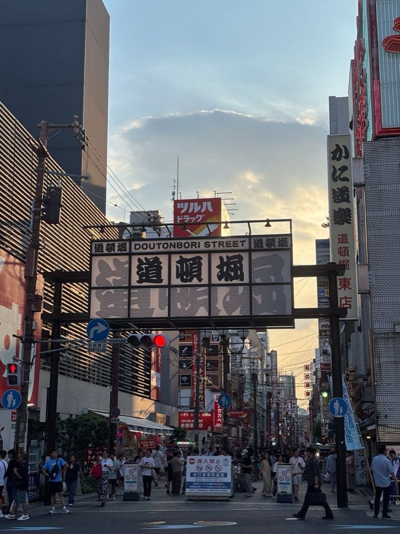 Dotonbori Street gate at sunset with crowds in Osaka