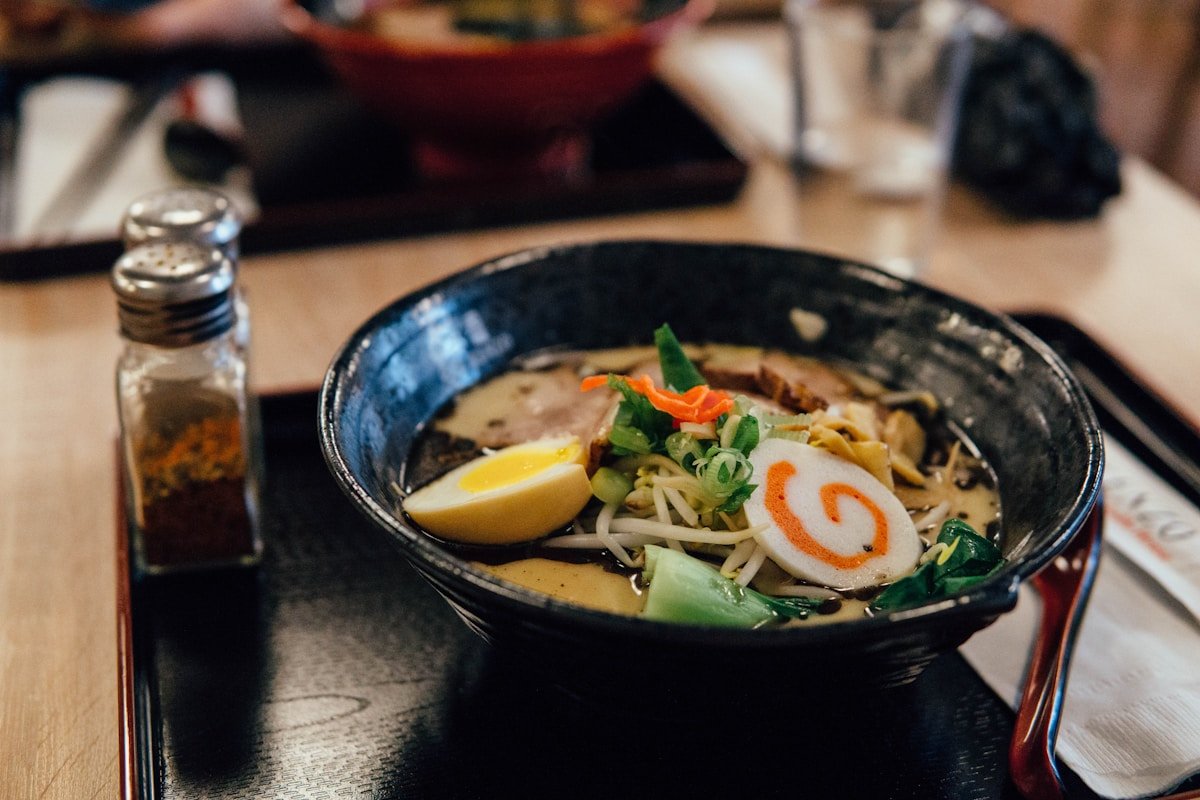 Ramen in bowl with condiment shakers — budget travel in Japan