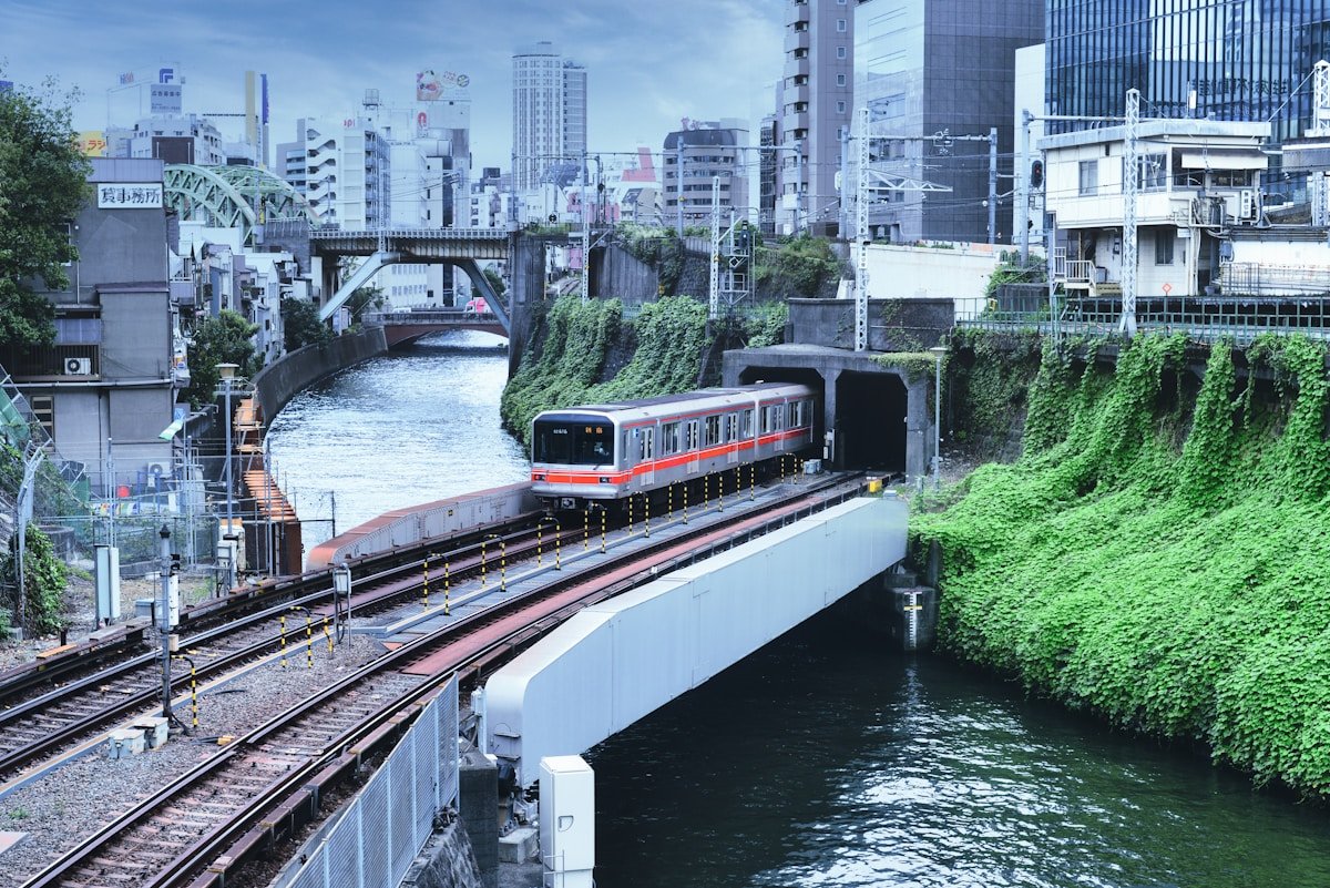 Red and white train on elevated rail near Tokyo — Haneda airport transfer guide