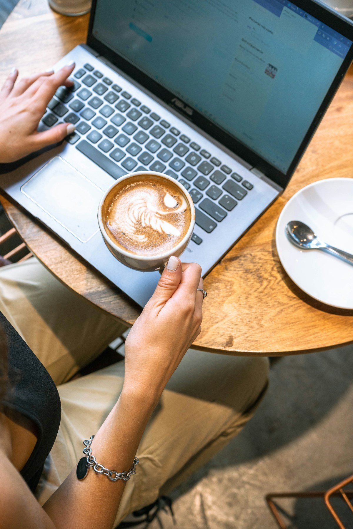 Person working on laptop with coffee — Japan digital nomad visa remote work guide
