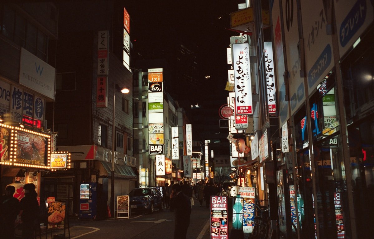 Street scene with glowing neon signs — Japan travel tips